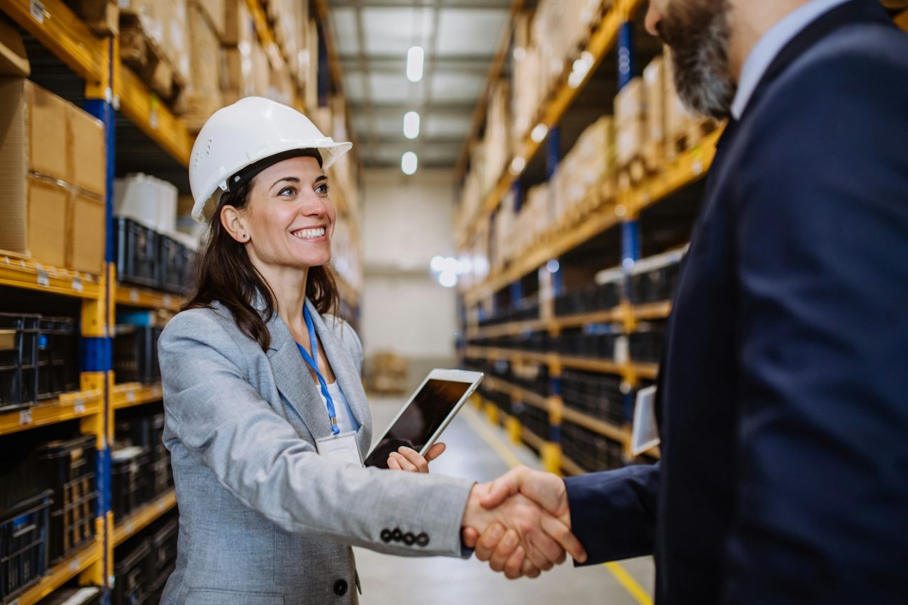 managers-in-suits-shaking-hands-in-warehouse-.jpg