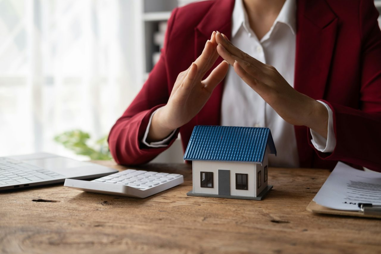 property-insurance-and-security-concept-protecting-gesture-of-man-and-symbol-of-house-.jpg
